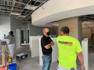 PAINTech contractors looking at a site How Our Decades Long Experience Can Help Your Bottom Line