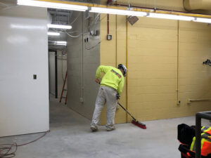 Man sweeping a polished concrete floor Why Commercial Concrete Polish Flooring Is Cost-Effective
