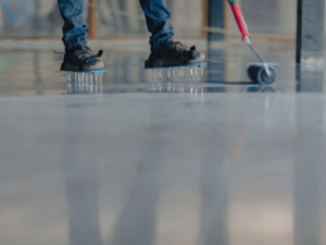 Man applying an epoxy coating to a garage floor Best Garage Floor Epoxy: What's Right for You?