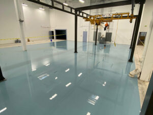New floor coating in a warehouse How to Decide Between Epoxy Floor Coating and Methyl-Methacrylate (MMA) Flooring