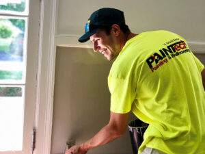 PAINTech employee working on an interior painting project How Commercial Interior Painting Can Help Your Budget in the Future