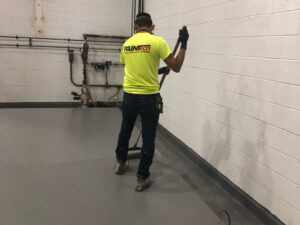PAINTech employee polishing floor Polish Concrete Flooring or Epoxy Flooring? What You Need to Know