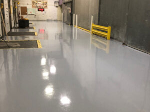 Epoxy floor coating in a facility The Many Pros of Commercial Epoxy Floor Coatings