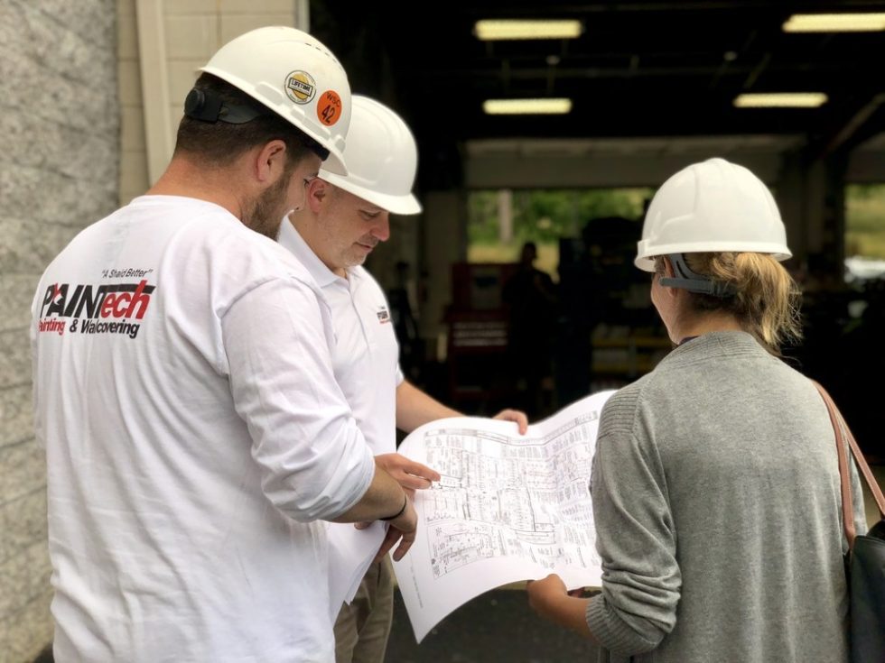 PAINTech employees viewing wallpaper installation plans