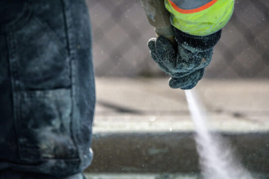 Worker sandblasting