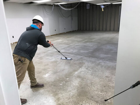 Contractor performing urethane cement flooring